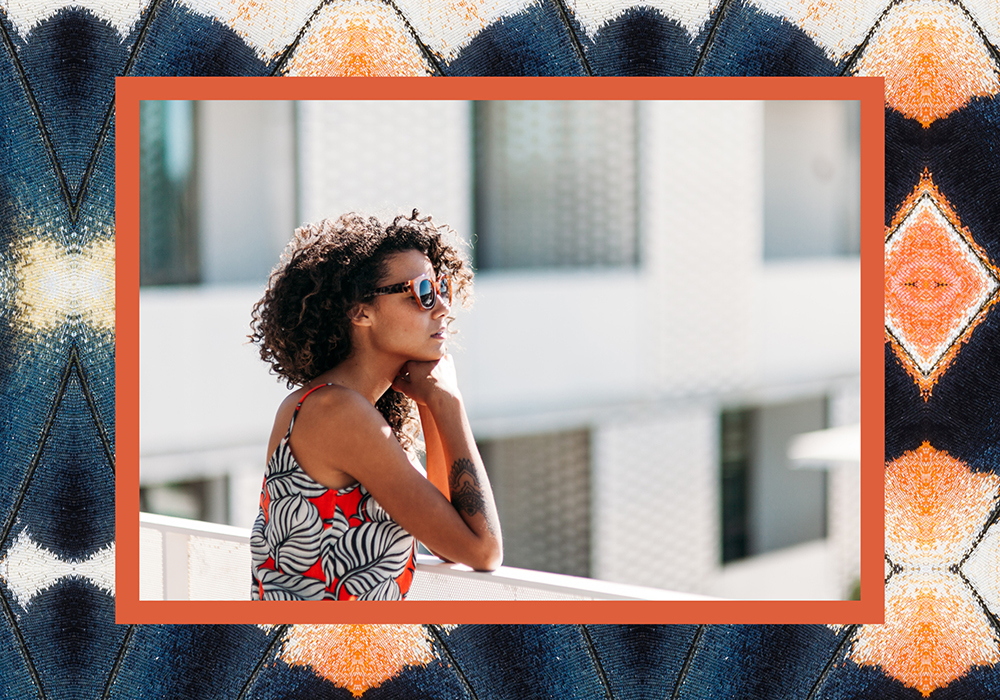 Rooftop deck with outdoor dining seating and BBQs with view of downtown Los Angeles skyline.