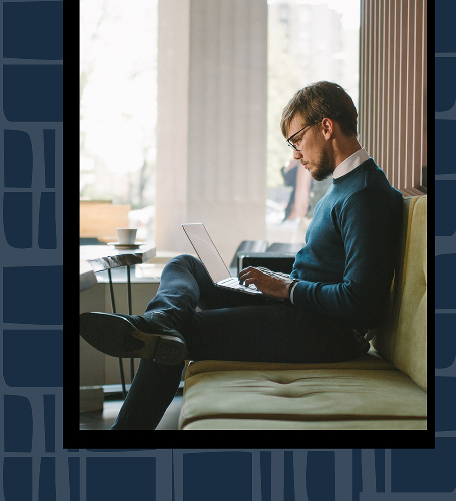 Stylish guy working on a laptop 