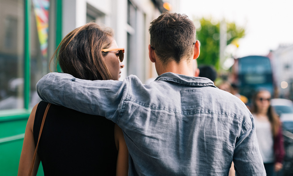 couple walking down city street
